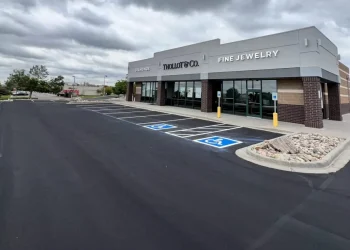 A new asphalt parking lot with new parking lot spaces, completed by National Pavement Partners