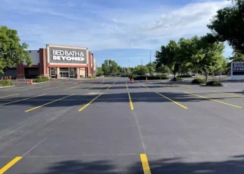 A new asphalt parking lot with new parking lot spaces, completed by National Pavement Partners