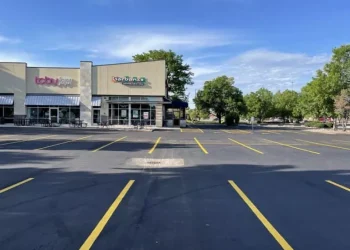 A new asphalt parking lot with new parking lot spaces, completed by National Pavement Partners