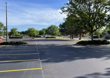 A new asphalt parking lot with new parking lot spaces, completed by National Pavement Partners