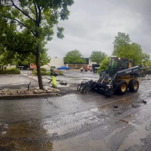National Pavement Partners works to tear up a parking lot on a rainy day.