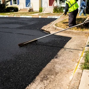 NPP workers smooth out freshly laid asphalt pavement